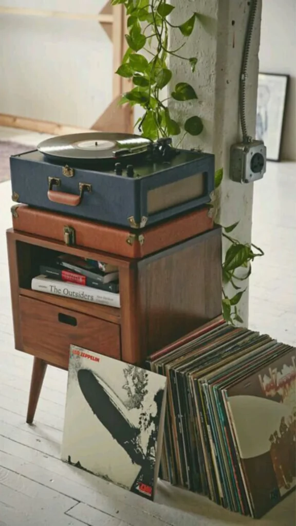 Classic Vinyl Records stnading next to a record player in wood - Best Vintage Gifts