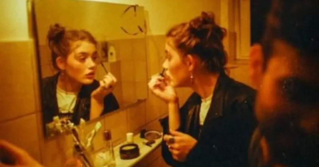 Vintage analog Photography of a girl in front of a mirror putting on her makeup - how to make photos look vintage